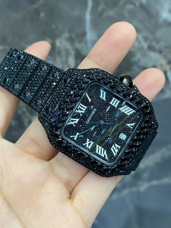 Discover the Full Iced Out Black Moissanite Cartier Santos Watch with All Black PVD coating. A bold luxury timepiece featuring moissanite brilliance, iced-out design, and sleek black finish for a modern, sophisticated look.